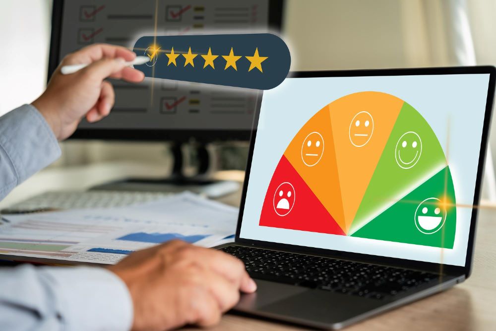 Une personne analyse la satisfaction clientèle à l'aide d'une évaluation NPS affichée sur un écran d'ordinateur  et donnant une note de cinq étoiles.