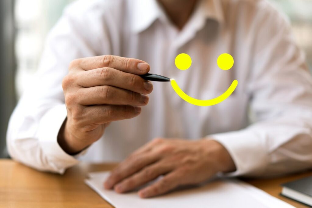 Illustration d'une personne dessinant un visage satisfait pour symboliser le dépôt d'un avis positif et exprimer la satisfaction.
